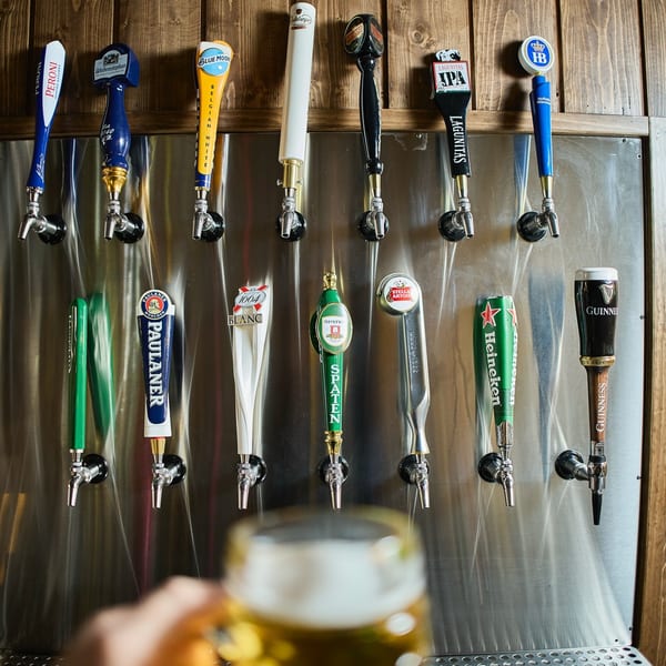 A variety of beer taps with different brand handles, including Guinness, Heineken, and Stella Artois.